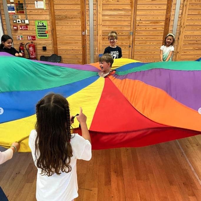 Young kids playing with flags at a summer holiday camp in london