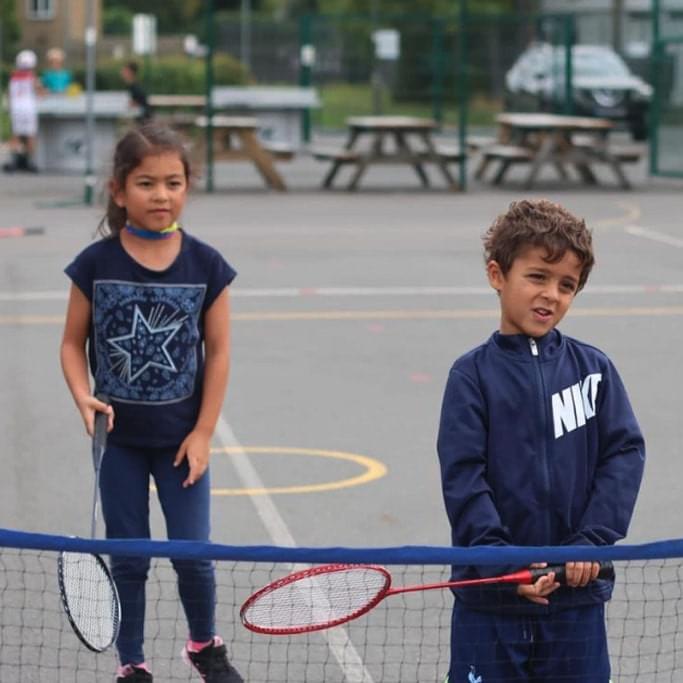 Young kids playing badminton at a children holiday camp in london