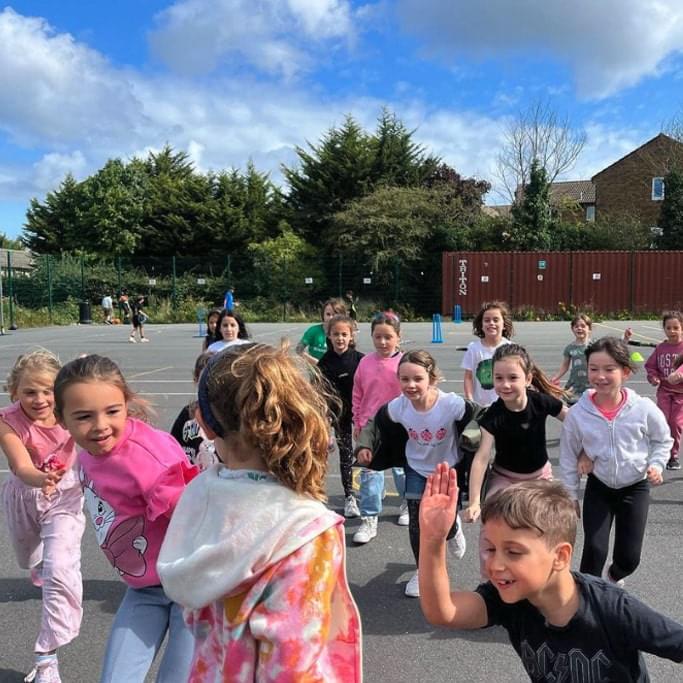 Bunch of children playing outside at a Rising Stars activities holiday camp