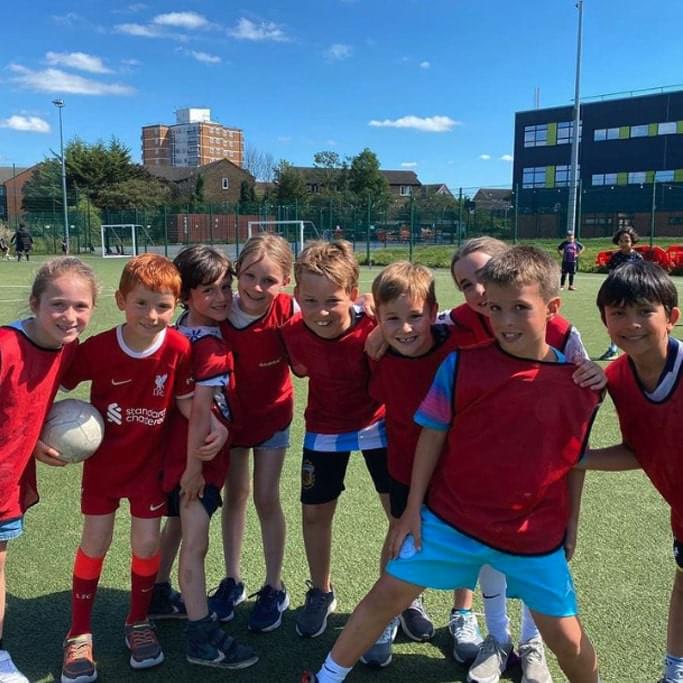 Young boys and girls at football practice